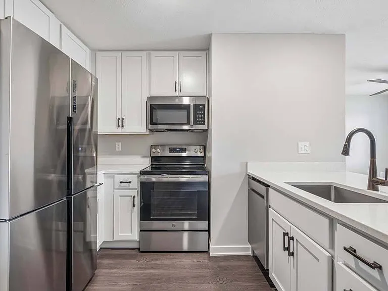 Clean lines, bright cabinetry, and stainless steel finishes come together in a modern kitchen designed to elevate everyday living.