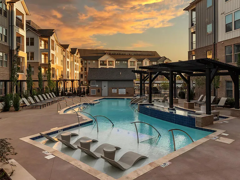 Modern Pool Surrounded by Lounge Chairs and Pergola Seating