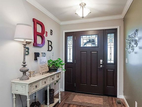 WELCOMING ENTRY SHOWS OFF THAT CRAFTSMAN DOOR AND BRAND NEW HIGH-END HICKORY LAMINATE FLOORING.