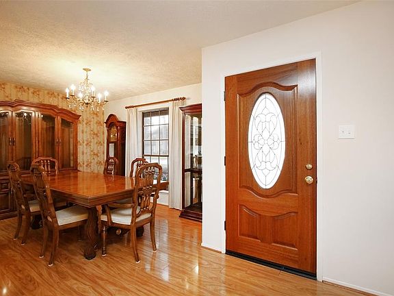Upon entry, you are welcomed by warm wood floors and an inviting dining and formal living room.
