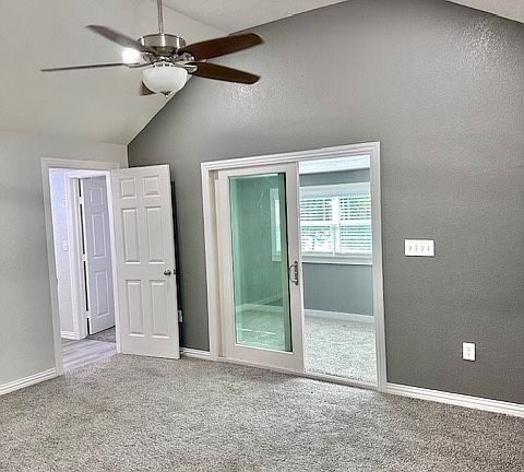 Primary bedroom leading out to wrap around sunroom with complete view of the lake