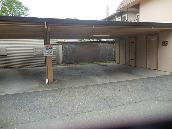 carport parking for one car, laundry room to right