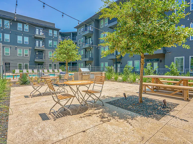Grilling area by the pool courtyard with stylish outdoor furniture