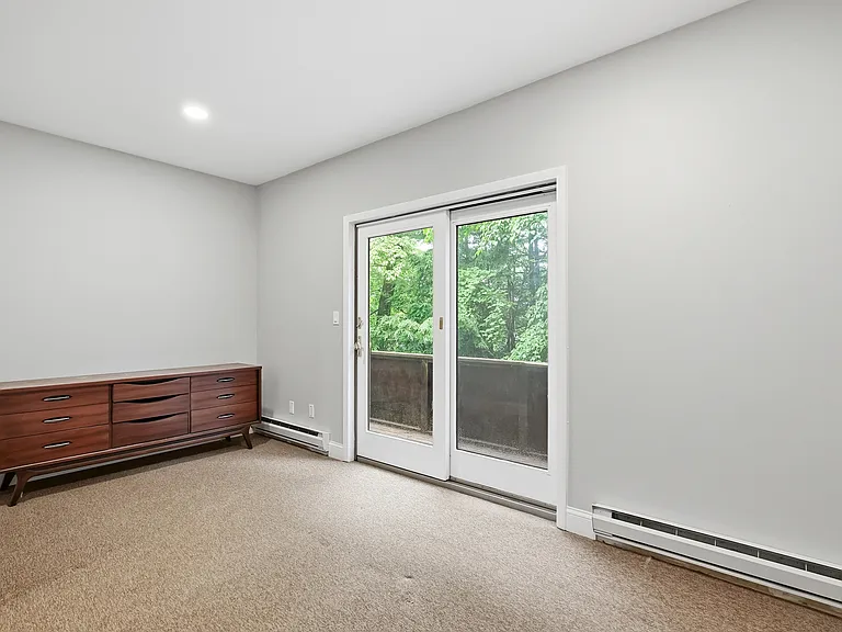 Lower level bedroom with sliders to small terrace