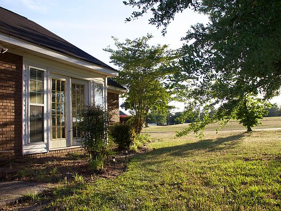 Rear view of duplex. French doors lead into the Florida room opens to the backyard with mature shade tree.