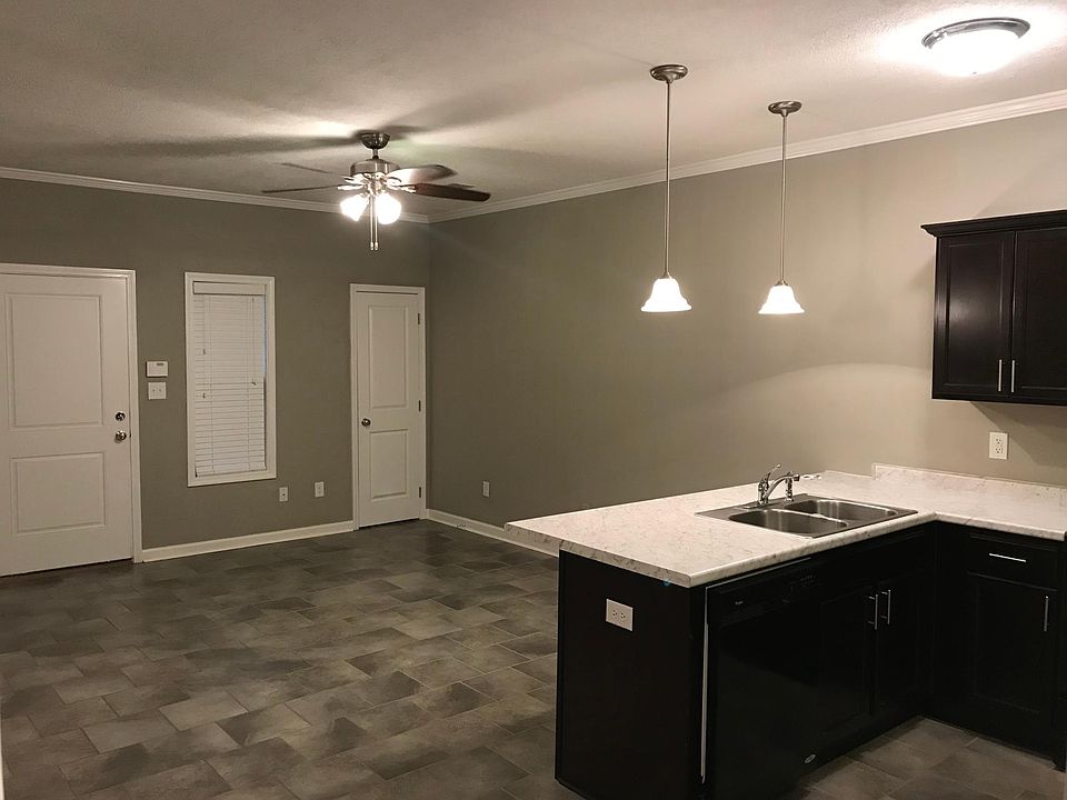 Living / kitchen combo, looking at entry into unit. Also notice counter overhang for bar stools as well as additional closet.