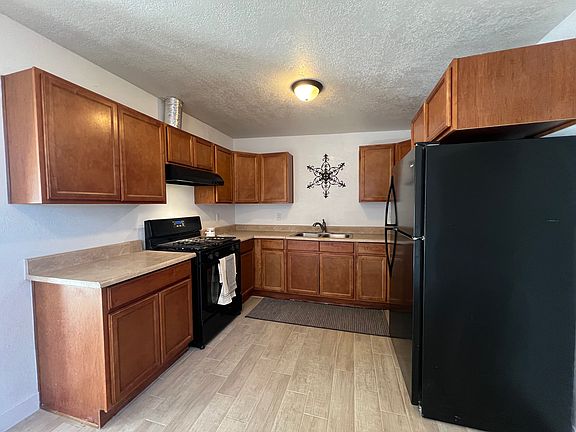 Kitchen comes with a stove, refrigerator, and garbage disposal