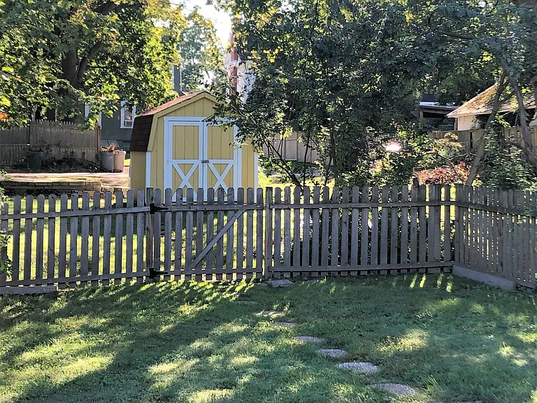 Large gated yard with storage shed