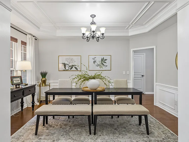 A stunning coffered ceiling and extensive custom millwork elevate this elegant dining room, creating the perfect backdrop for holiday celebrations, dinner parties, and everyday enjoyment with friends and family.