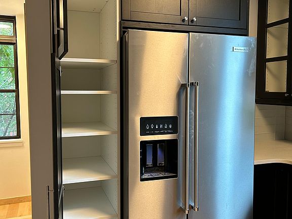 French door refrigerator with water and ice dispenser. Large pantry.