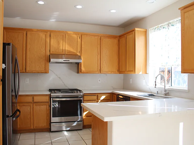 kitchen updated with new quartz countertop, sink, and natural gas range