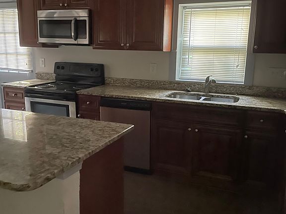 Granite countertops, custom cabinets, and stainless steel appliances