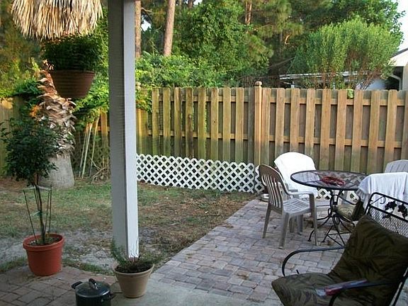 Fenced Backyard with Covered Patio and Eating Area