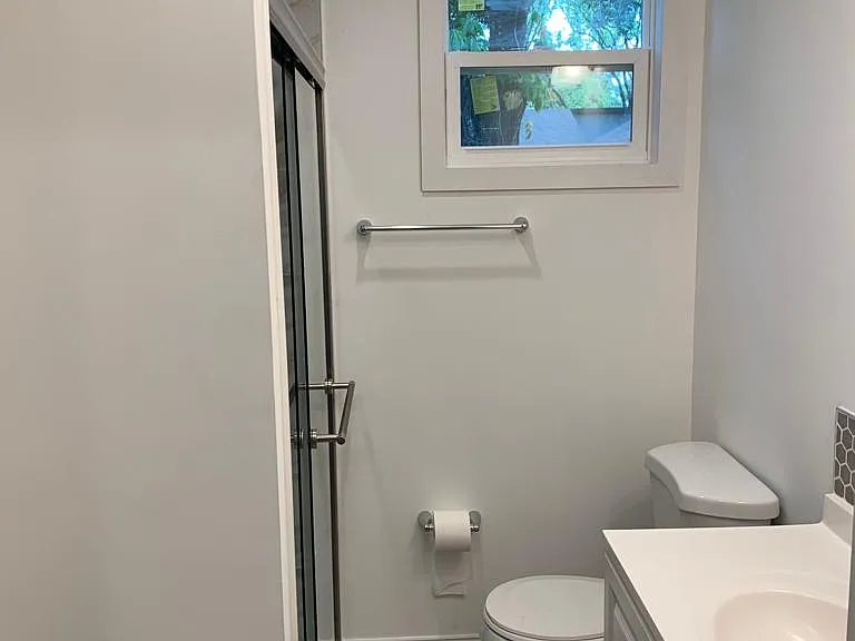 Spotless bathroom in excellent condition featuring a sink, toilet, and storage drawer for essentials. Lakeland, FL