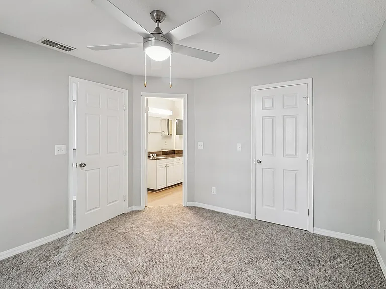 Spacious bedroom with convenient access to bathroom and storage
