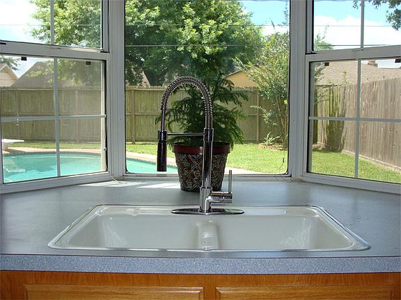 Kitchen Sink has a view of the Pool.