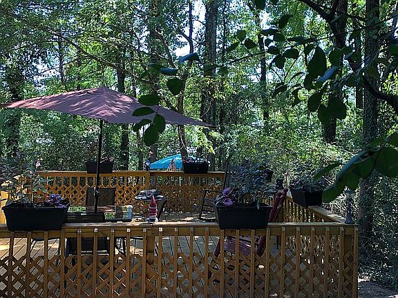 Beautiful deck by woods 