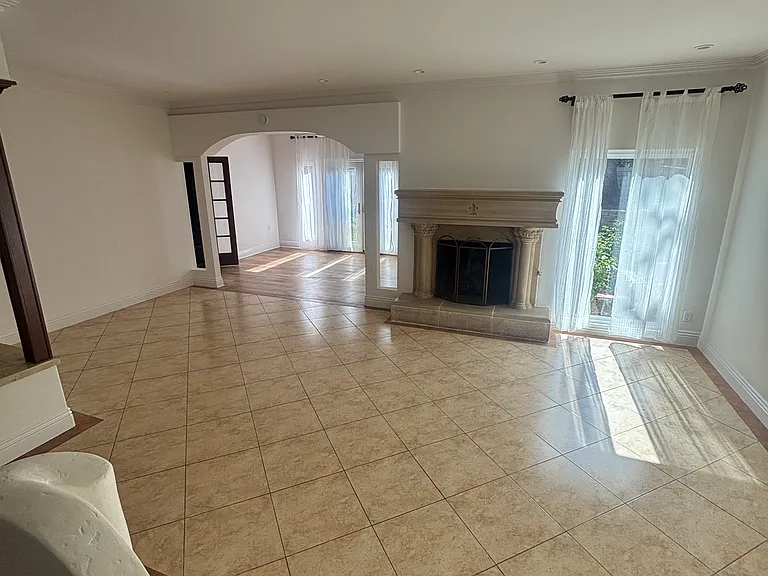 living room and in the far view formal dining room facing the backyard