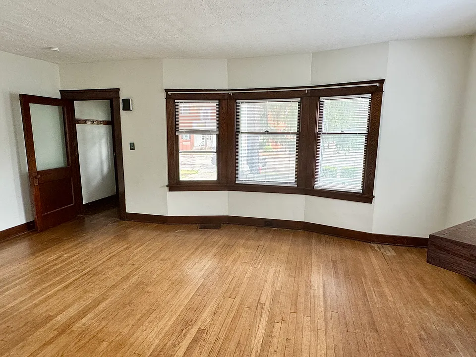 Living room with hardwood floors and bay windows
