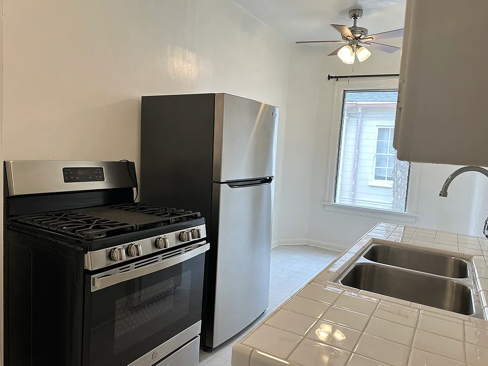 Kitchen with gas stove and refrigerator