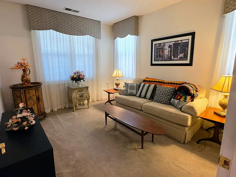 Generously sized secondary bedroom featuring massive windows, deep crown molding, and beautiful natural light.