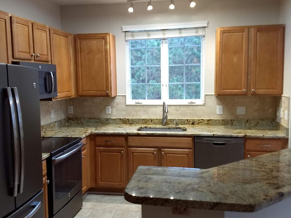 Granite countertops, stainless steel appliances, plenty of cabinets. Kitchen overlooks greenway.