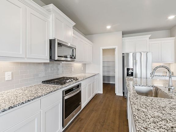 Kitchen in the Ryder home plan by Trophy Signature Homes - REPRESENTATIVE PHOTO