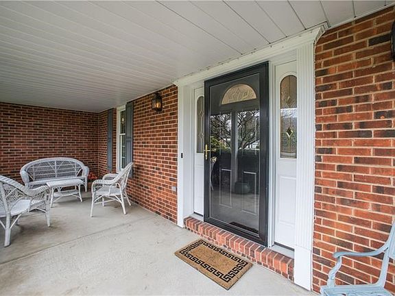 Bring a bottle of wine to your showing and just relax on this porch like it's yours!