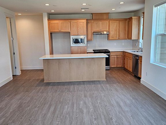 Kitchen with Wood Cabinets & Quartz Counter tops