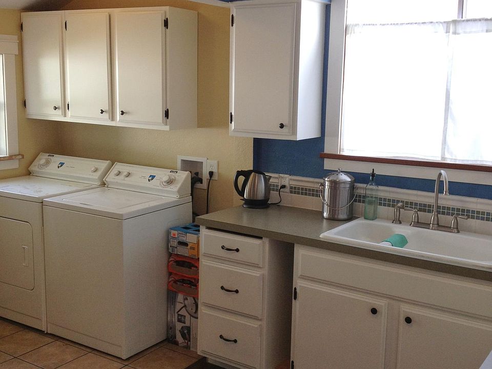 In suite laundry with tile floor.