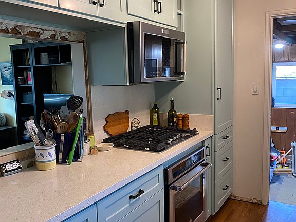 Renovated Kitchen with custom cabinets. Door leads to garage.
