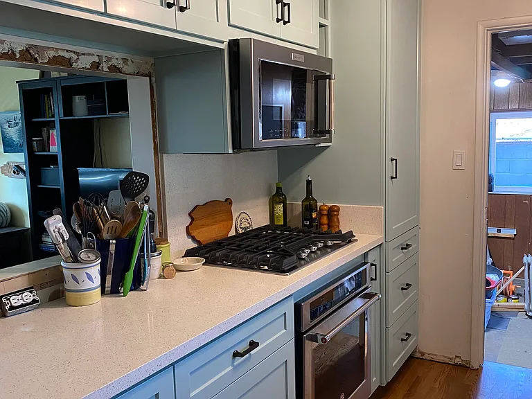 Renovated Kitchen with custom cabinets. Door leads to garage.