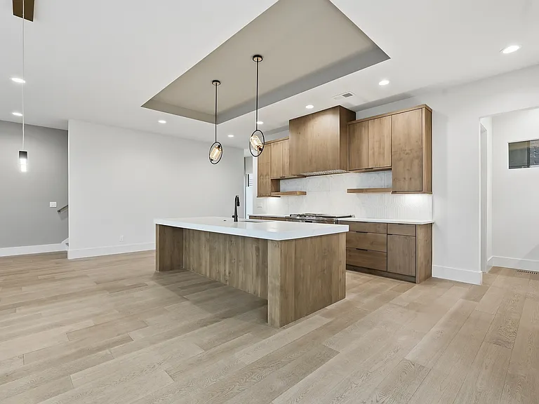 Designer kitchen featuring statement lighting and large island