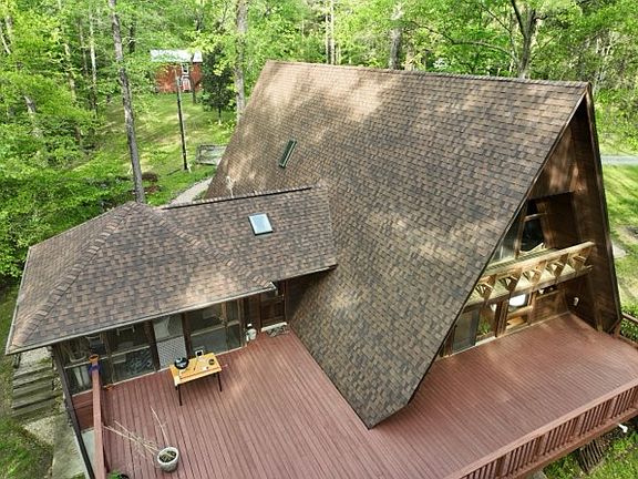 Aerial view of deck, and screened in porch on the left.