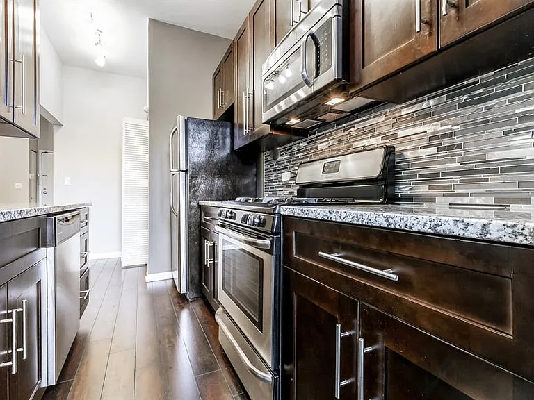 Updated kitchen with granite counter top and stainless steel appliances