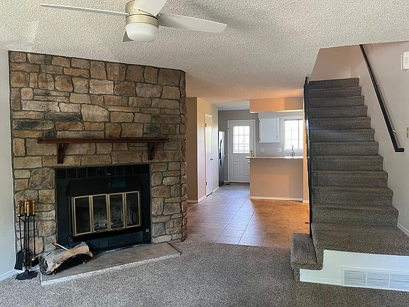 Large wood burning fireplace, dining area and kitchen