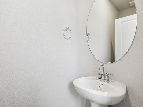 The first-floor powder bathroom is convenient for guests.