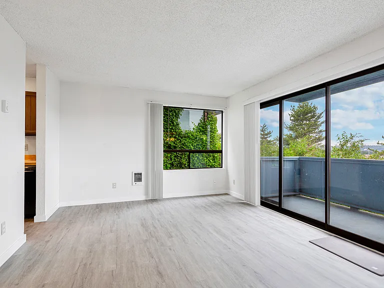 Bright and spacious living with big sliding door to private deck