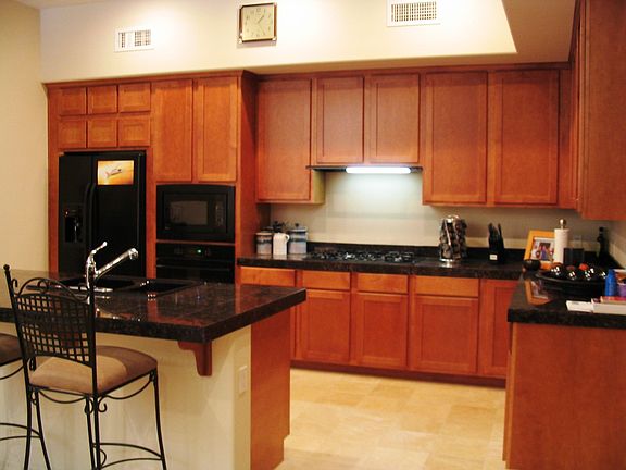 Granite countertops, 42 inch cabinets, travertine floor
