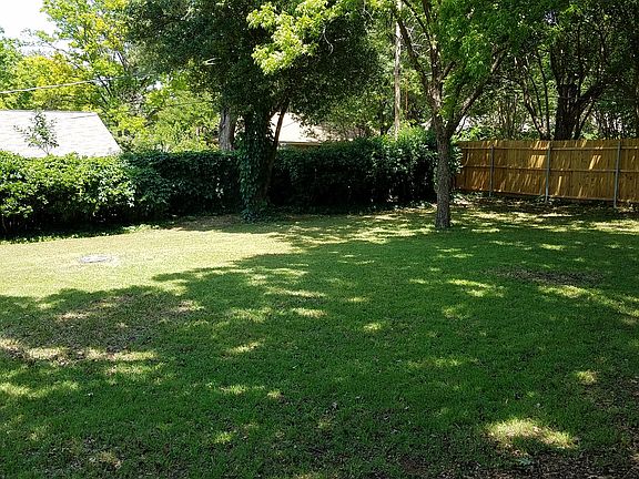 Spacious tree-shaded backyar