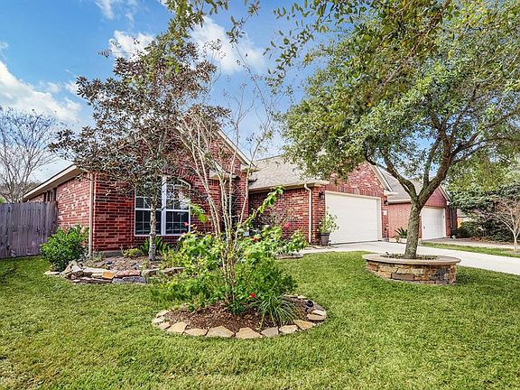 This home has great curb appeal with brick on four sides, rain gutters, handsome outdoor lighting, raised beds and a large shade tree in the font yard.