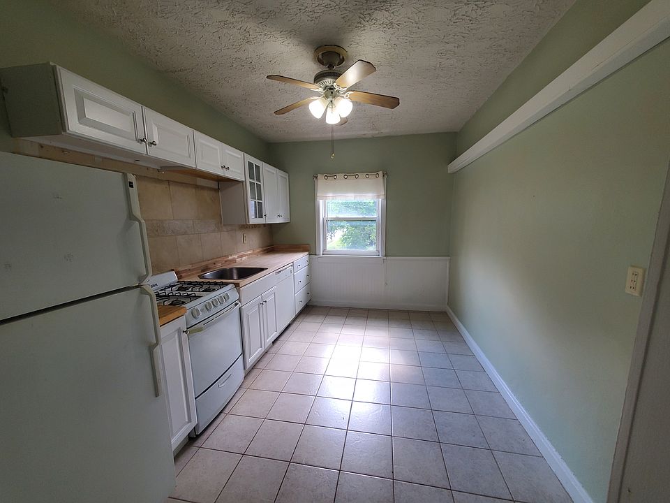 Newer kitchen cabinets, rectangle farmhouse style sink, butcher block style counter top