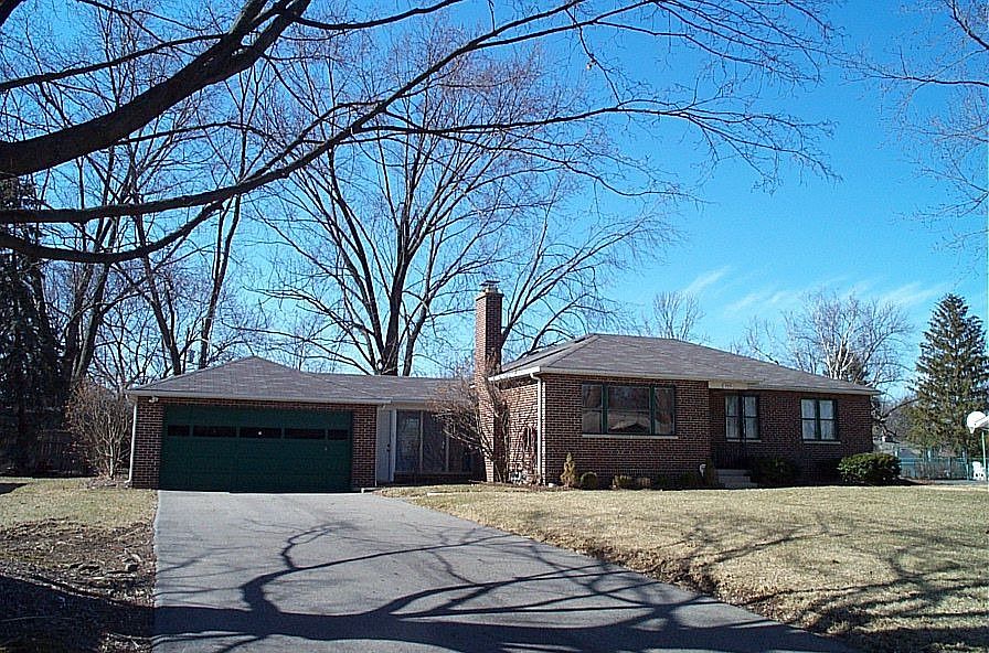 This custom build Georg Moor brick ranch is situated on a tree lined street.  