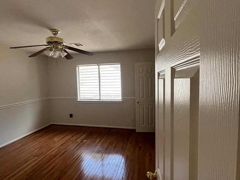 Upstairs Bedroom Two - beautiful glowing wood floors match the main staircase. Also has a small walk-in closet (door back right). Lovely and comfortable room.