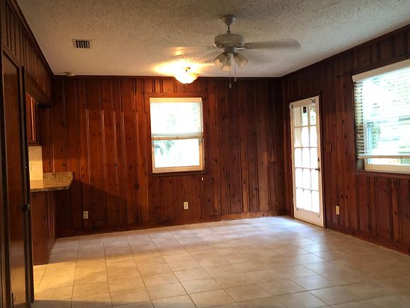 Family room with breakfast bar on the left and door to back yard on the right.