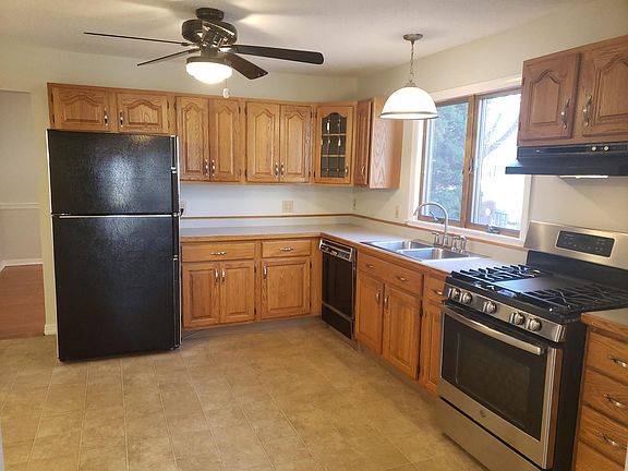 Kitchen window faces the driveway. Kitchen features ample storage space, refrigerator, dishwasher, sink, brand new stove and pantry.