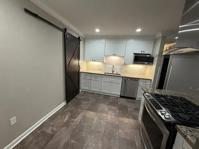 Barn door leads to inside laundry room