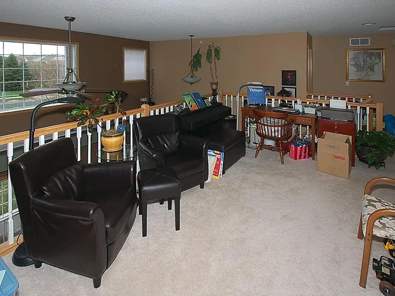 Large loft over looking the living room; can convert to den and office.
