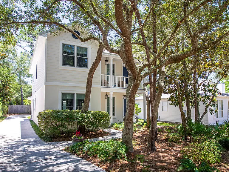 Landscaped yard and mature trees line the property.