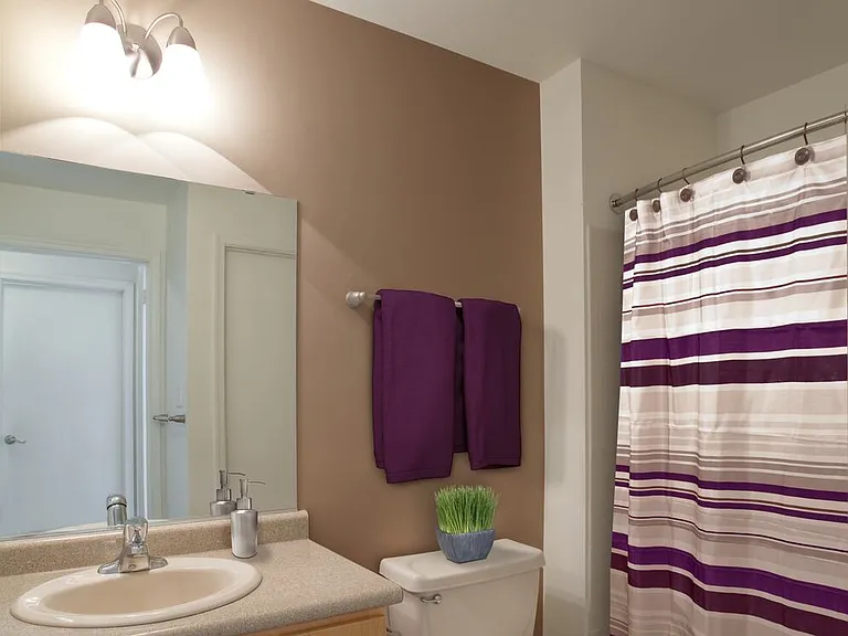 Classic Package bath with grey laminate countertops, oak cabinetry, and hard surface flooring
